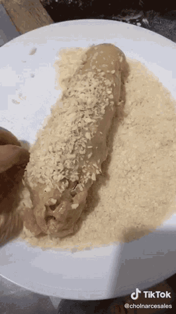 a tiktok video shows a person dipping a food in crumbs