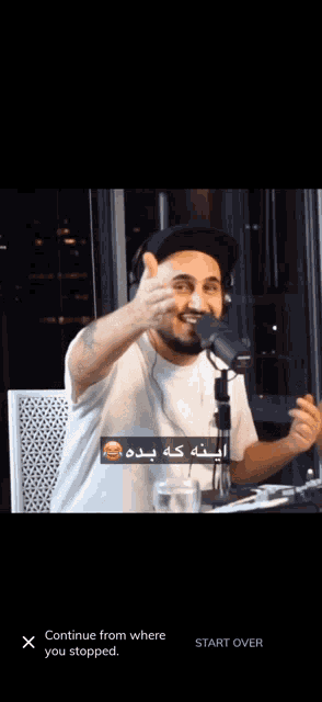 a man wearing headphones and a hat is talking into a microphone with the words continue from where you stopped on the bottom