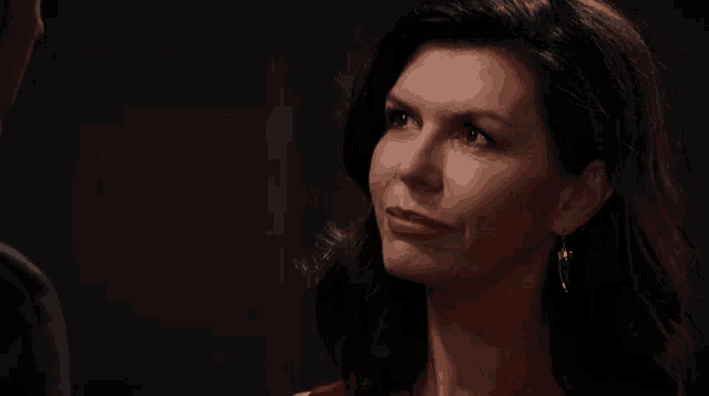 a woman in a red dress is looking at a man in a black suit .