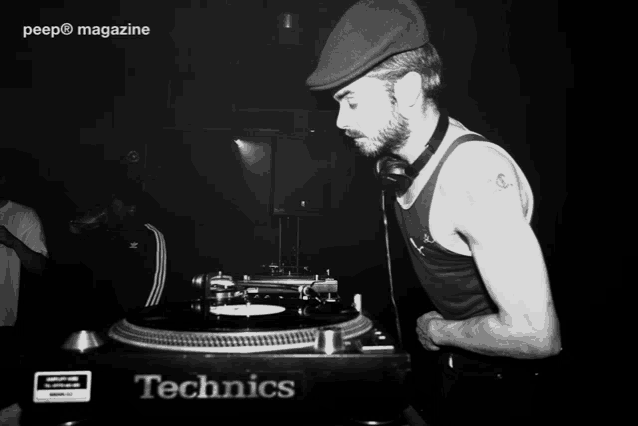 a peep magazine photo of a man playing records on a technics turntable