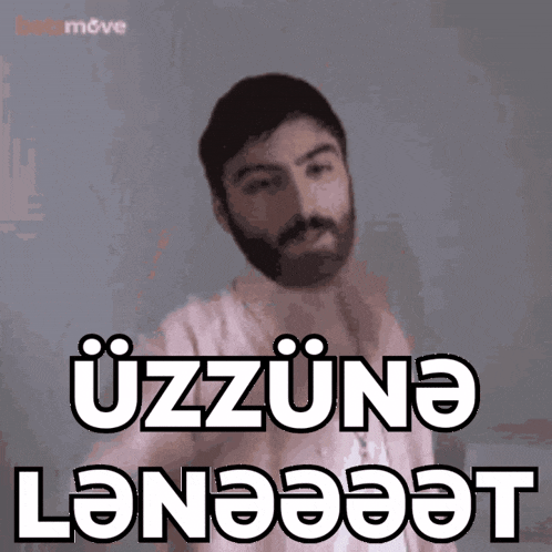 a man with a beard has the word uzuna written on his shirt