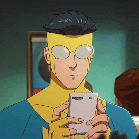 a cartoon superhero is holding a cell phone in his hand