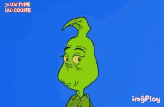 a cartoon character grinch is smiling and making a funny face against a blue background .