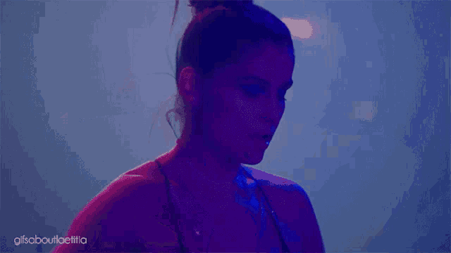 a gif of a woman 's face with the words gifsaboutioelilia written below it
