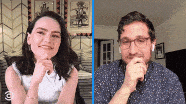 a man and a woman are sitting next to each other on a couch and smiling