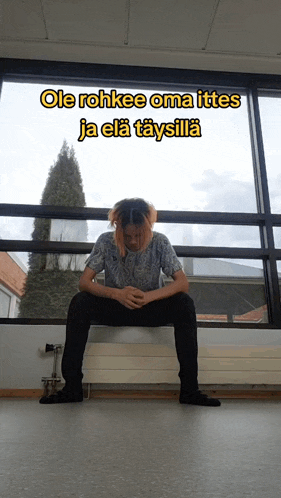 a man squatting down in front of a window with the words ole rohkee oma ittes ja ela taysilla written above him