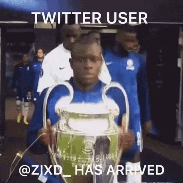 a man holding a trophy with the twitter user @zixd_has arrived