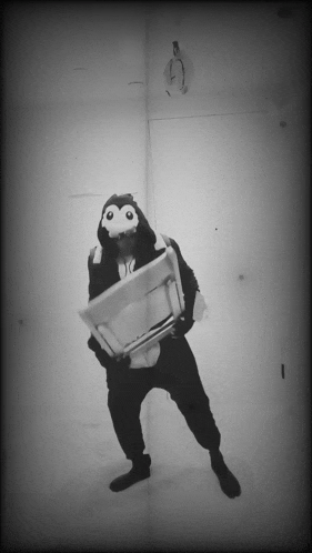a black and white photo of a person in a monkey costume