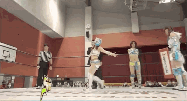 a woman in a wrestling ring with a sign that says bushiroad on it
