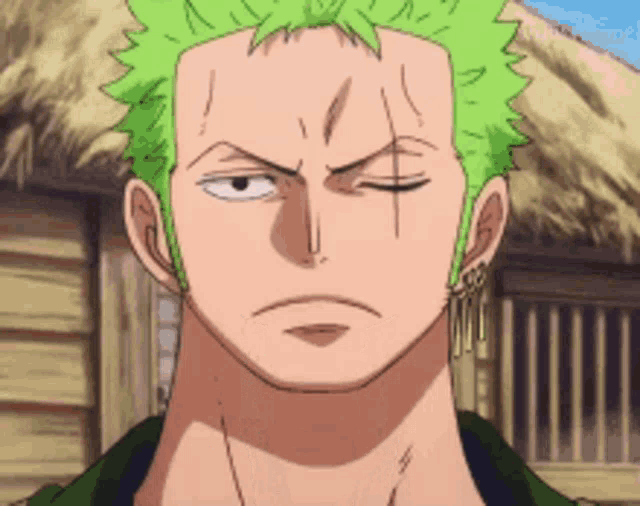 a close up of a man 's face with green hair and earrings .