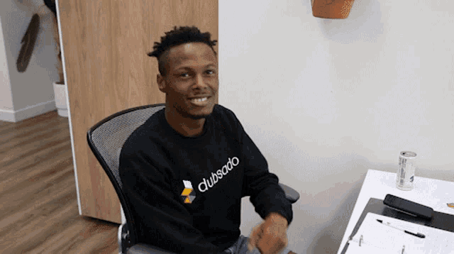 a man wearing a black sweatshirt that says clubsaido