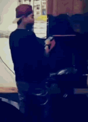 a man wearing a red hat is looking at his cell phone