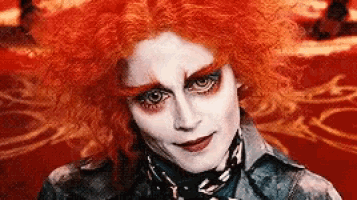 a close up of a person 's face with red hair .