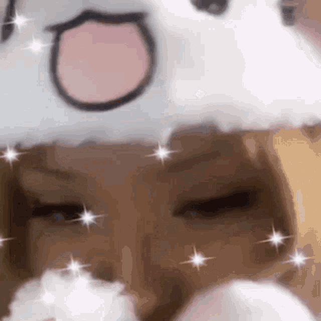 a close up of a person wearing a white hat with a cat face on it .
