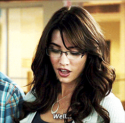 a woman wearing glasses and a necklace says " well "