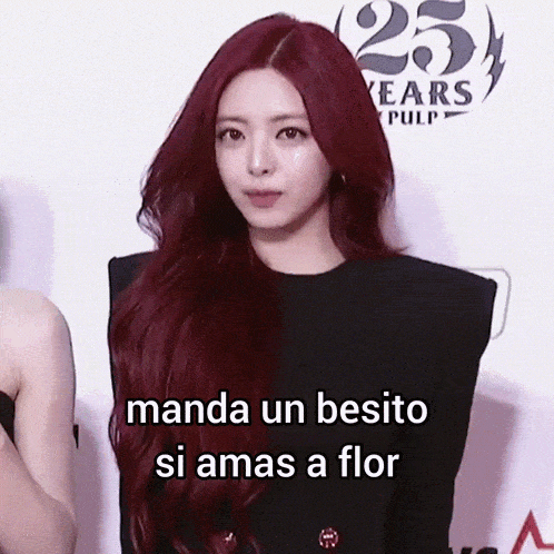 a woman with red hair is standing in front of a sign that says 25 years of pulp