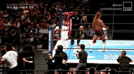 a wrestler in a ring with the number 127 on the corner
