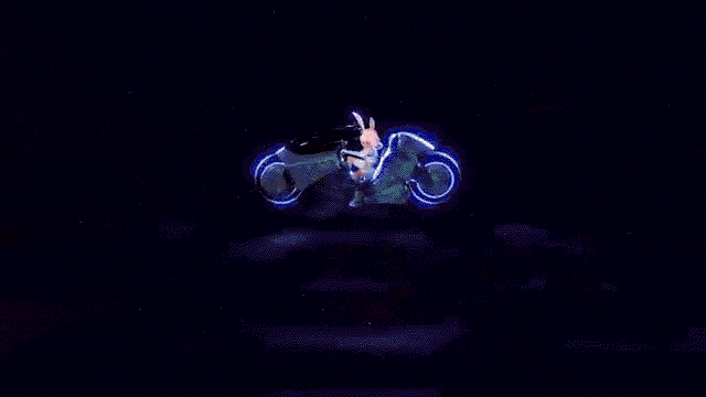 two rabbits are dancing on a stage in front of a crowd