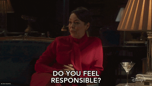 a woman in a red dress is sitting on a couch with a martini and says do you feel responsible