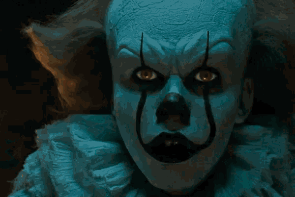 a clown in a dark room with a stained glass window
