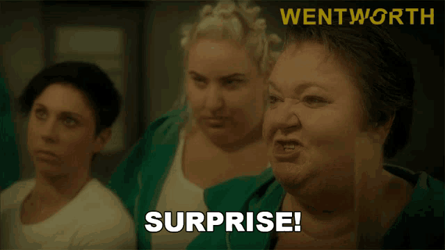 a woman says surprise in front of a wentworth ad