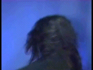 a blurry picture of a person 's face with a blue background