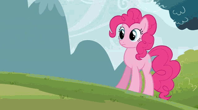 pinkie pie from my little pony stands on a grassy hillside