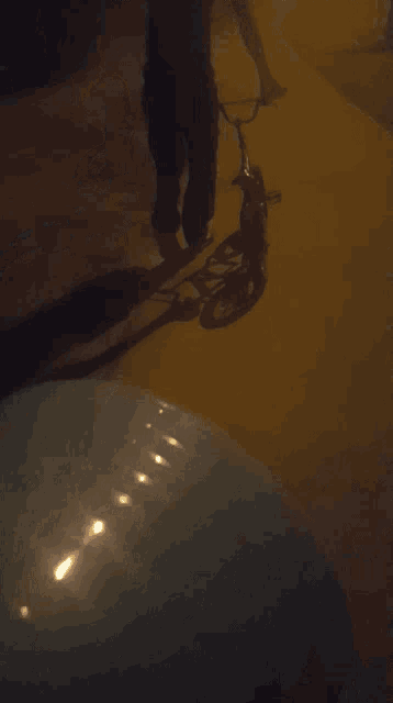 a person is riding a scooter on a sidewalk at night