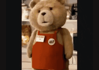 a teddy bear wearing a red apron with a help badge on it .