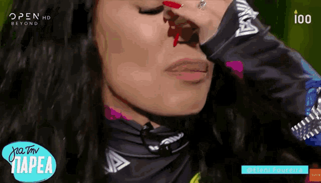 a close up of a woman 's face with open hd beyond in the corner