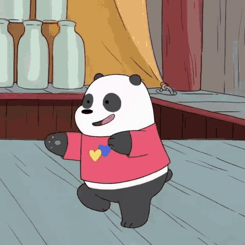a panda bear in a pink shirt with a heart on it