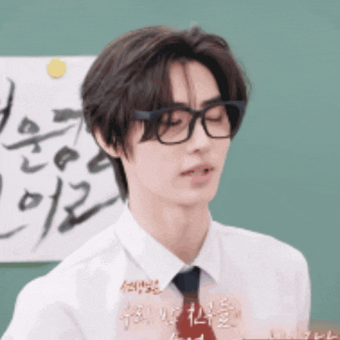 a young man wearing glasses and a white shirt with a tie