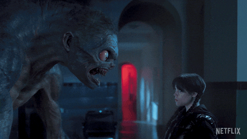 a girl standing next to a monster with a netflix logo on the bottom