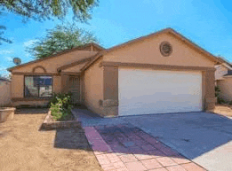 the front of a house with a white garage door and a driveway .