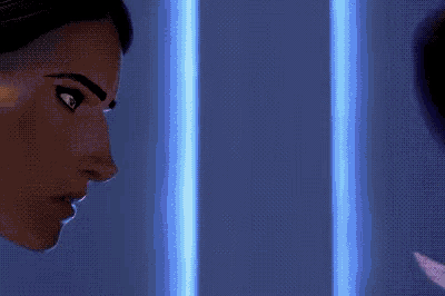 two women are looking at each other in a dark room with blue lights behind them