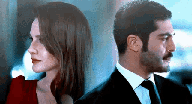 a man and a woman are standing next to each other