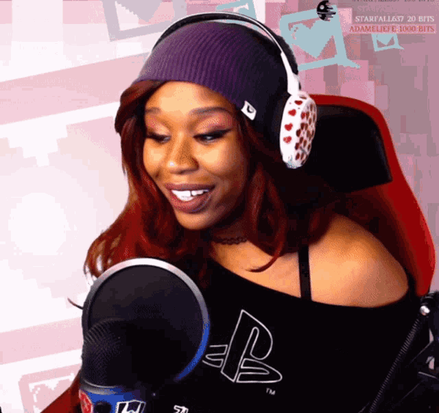 a woman wearing headphones and a shirt that says playstation