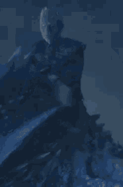 a man in a blue costume is riding a blue dragon in the dark .