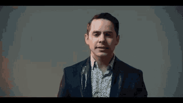 a man in a suit and white shirt is making a funny face .