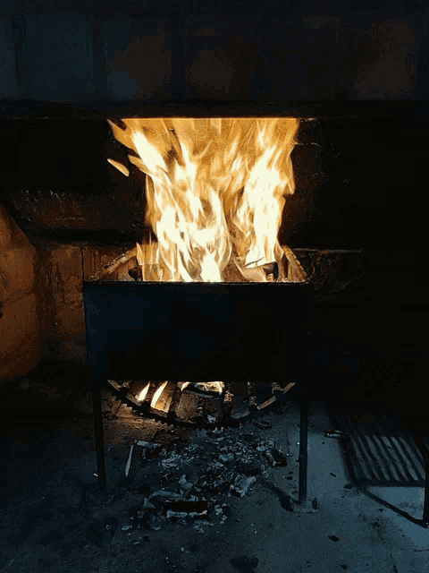 a large fire is burning in a metal container