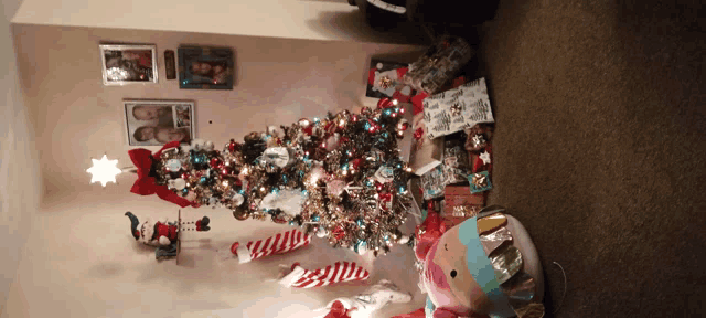 a christmas tree in a living room with gifts underneath