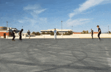 a group of people are playing a game on a rooftop