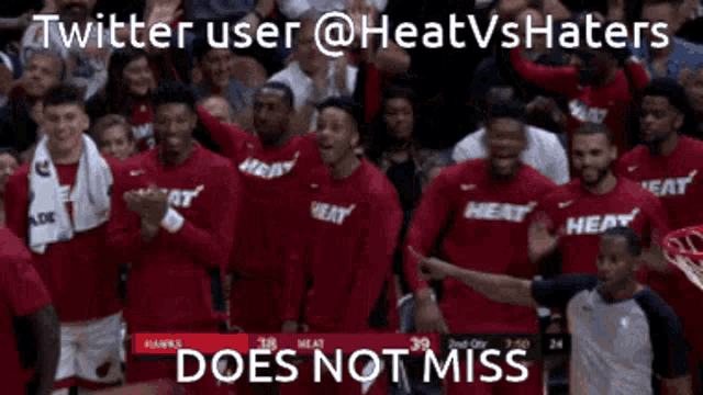 a group of basketball players wearing heat shirts celebrate