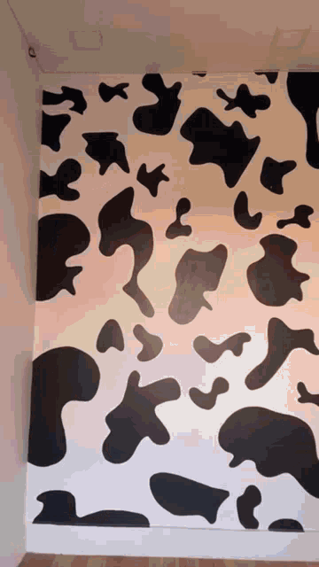 a black and white cow print on a wall