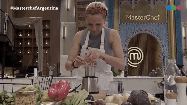 a woman prepares food in front of a wall that says master chef argentina