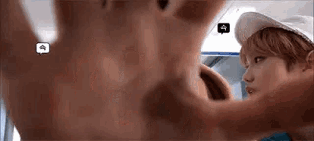 a close up of a person 's hand reaching out towards another person on a bus .