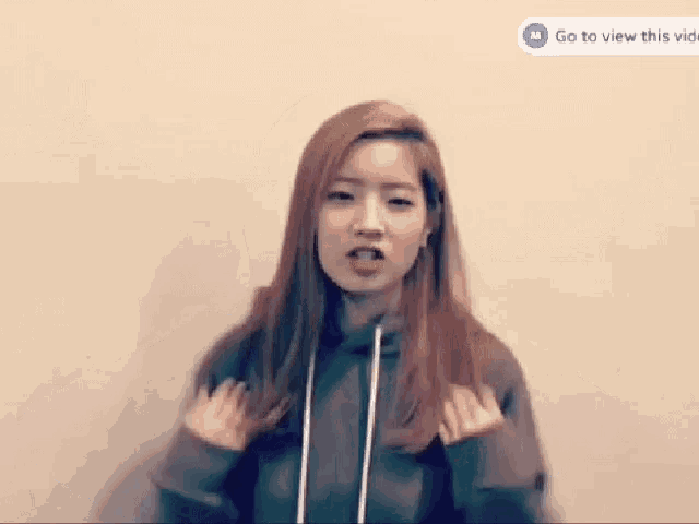 a woman with her arms outstretched and a go to view this video button on the bottom