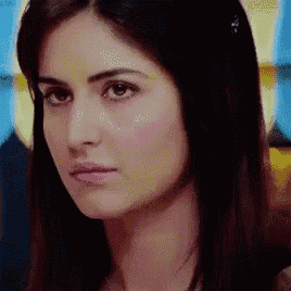 a close up of a woman 's face with a blurred background