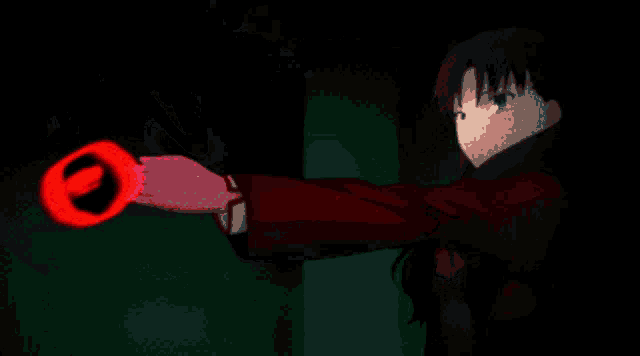 a girl is holding a red circle with a black circle in the middle