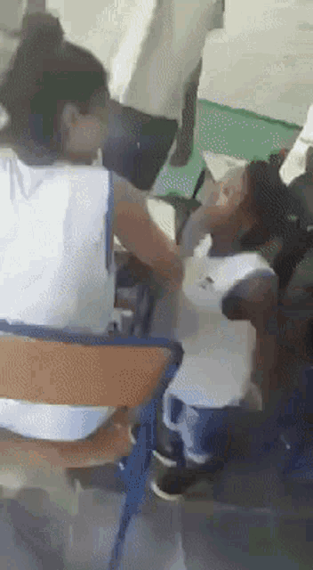 a woman in a white shirt is holding a baby